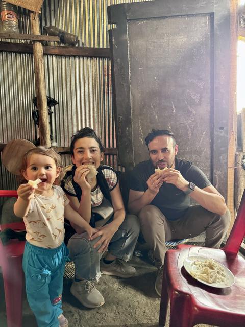 Sharing a simple meal with a local family in a tin house