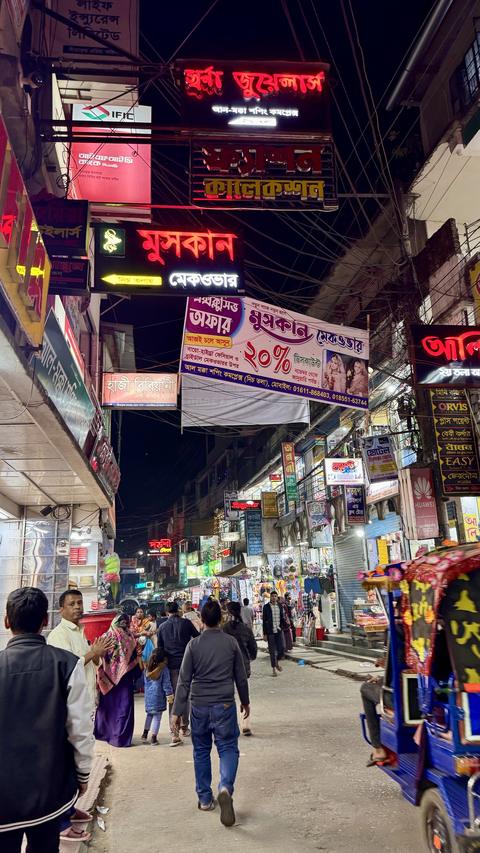 Night market—bright neon shop signs and busy sidewalks