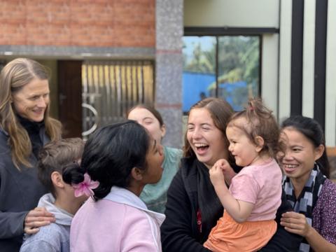Laughing with friends outside the community center