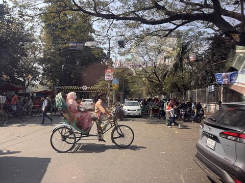 City street with rickshaw and traffic
