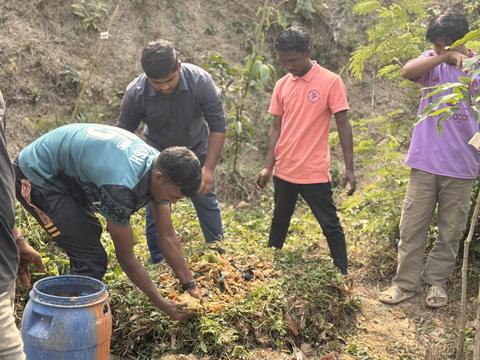 Aerobic compost — students adding materials to the pile